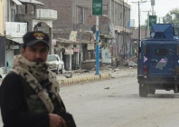 a police officer stands guard on a street with damaged shops in the background in bannu khyber pakhtunkhwa photo afp a police officer stands guard on a street with damaged shops in the background in bannu khyber pakhtunkhwa photo afp
