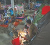 a displaced family uses a flashlight as they eat a meal at a temporary camp along the cambodia thailand border photo afp