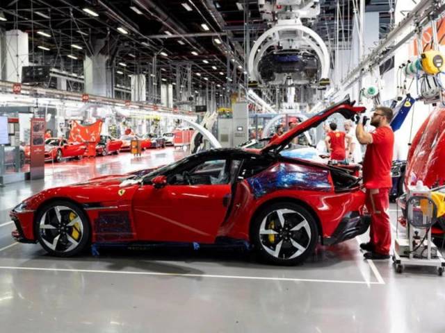 a ferrari worker inspects a car inside the company s factory in maranello italy source reuters a ferrari worker inspects a car inside the company s factory in maranello italy source reuters