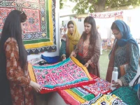 women explore and purchase traditional sindhi items from cultural stalls at the 8th sindh literature festival which also features literature sessions live music and awards honoring youth achievers photo jalal qureshi express