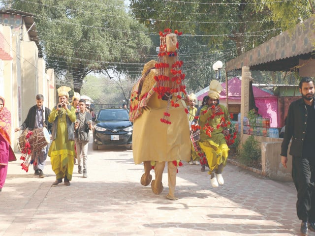 federal secretary for national heritage and culture hassan nasir jamy enters the rang e pakistan festival venue in a procession led by a decorated camel photo express