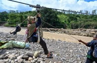 people use a rope to cross a river in the aftermath of flash floods that destroyed adjacent villages in ketol indonesia s aceh highland province on january 6 2026 photo afp people use a rope to cross a river in the aftermath of flash floods that destroyed adjacent villages in ketol indonesia s aceh highland province on january 6 2026 photo afp