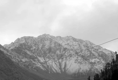 the snowcovered slopes set against a dramatic overcast sky and framed by towering evergreen trees offer a striking glimpse of the region s natural beauty as the weather turns colder photo online