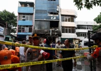 police officers stand near a seven storey building damaged by fire in jakarta indonesia december 9 2025 photo reuters