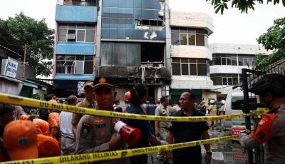 police officers stand near a seven storey building damaged by fire in jakarta indonesia december 9 2025 photo reuters