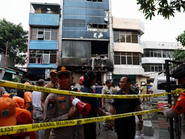 police officers stand near a seven storey building damaged by fire in jakarta indonesia december 9 2025 photo reuters police officers stand near a seven storey building damaged by fire in jakarta indonesia december 9 2025 photo reuters