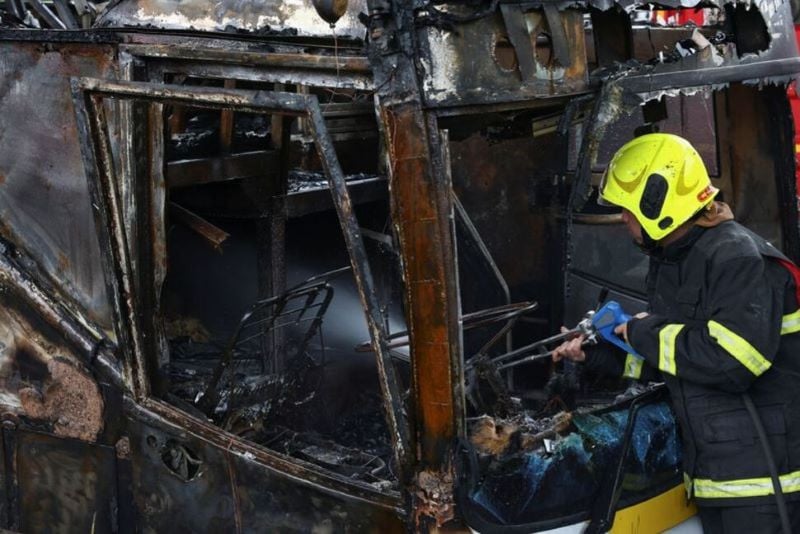 firefighter works to extinguish a burning bus that was carrying teachers and students from wat khao phraya school reportedly killing almost a dozen on the outskirts of bangkok thailand october 1 2024 photo reuters