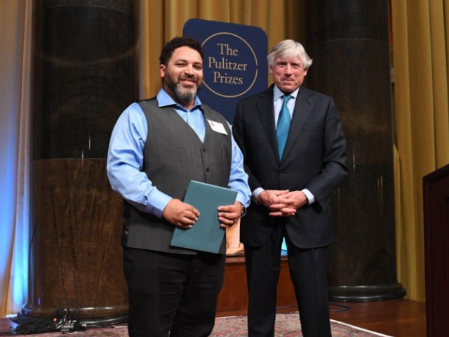 Darrin Bell accepts the 2019 Pulitzer Prize for Editorial Cartooning from Columbia University President Lee Bollinger.