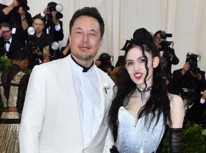 grimes defends elon musk against climate denier accusations while evacuating from the l a fires