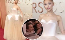 ariana grande s 190 000 crystal defying gravity dress at the 2025 oscars doubles as a phone stand