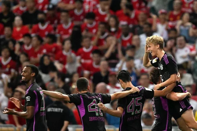 bayern munich s frans kratzig r celebrates after scoring a goal against liverpool during their singapore festival of football pre season friendly match in singapore on august 2 photo afp bayern munich s frans kratzig r celebrates after scoring a goal against liverpool during their singapore festival of football pre season friendly match in singapore on august 2 photo afp