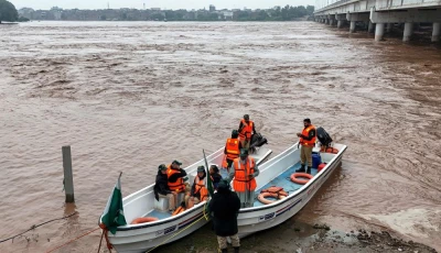 this aerial photograph shows rescue personnel preparing to patrol along the flooded ravi river following a rise in water levels near residential areas in shahdara lahore on august 29 2025 photo afp