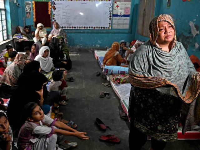 tabassum suleman an evacuated resident from her submerged home speaks during an interview photo afp