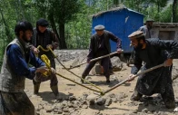 afghan residents clear sludge from a street after heavy rain showers induced flash floods in the khash district of badakhshan province on may 22 2026 photo afp