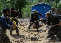 afghan residents clear sludge from a street after heavy rain showers induced flash floods in the khash district of badakhshan province on may 22 2026 photo afp