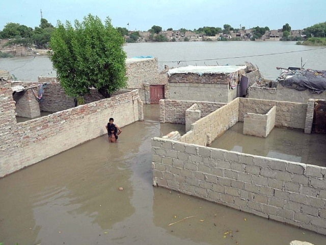 a man carries a child on his shoulders after floodwater enters houses in the kacha area in hyderabad photo app