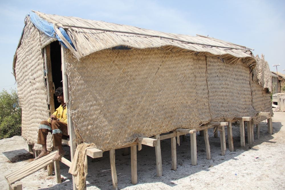 A fisherman in raised platform wooden shack in Kharo Chhan area of Sindh Delta. PHOTO: SUHAIL YUSUF