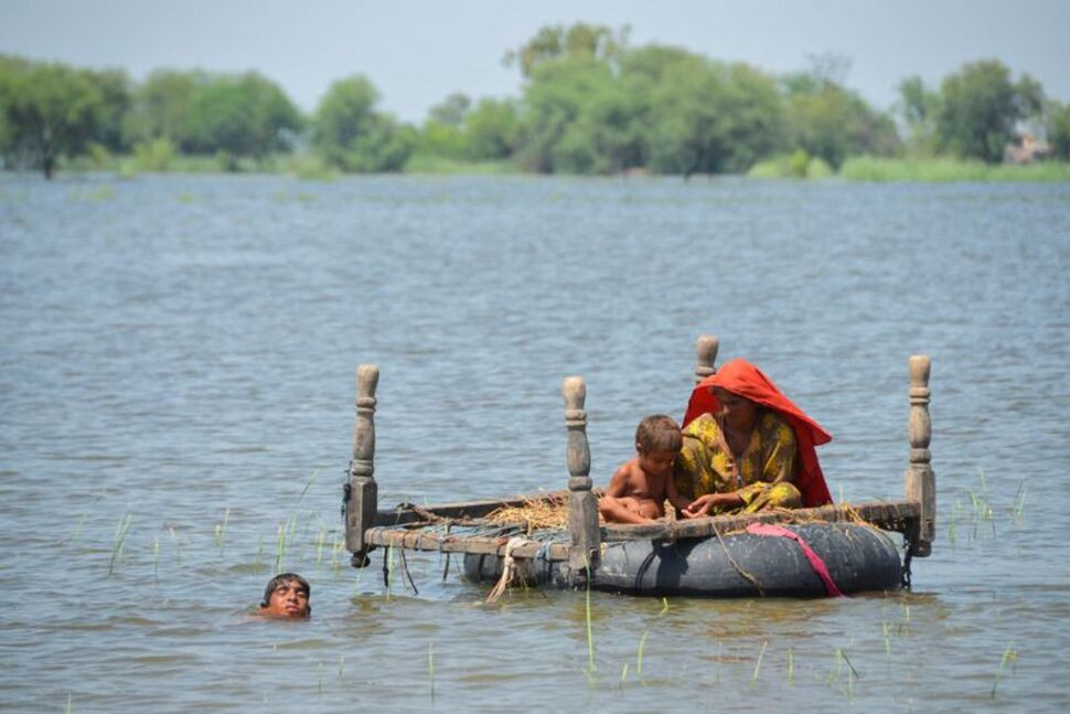 flood victims use an inflatable tube as they travel in flood waters following rains and floods during the monsoon season in dera allah yar jafferabad pakistan august 31 2022 photo reuters