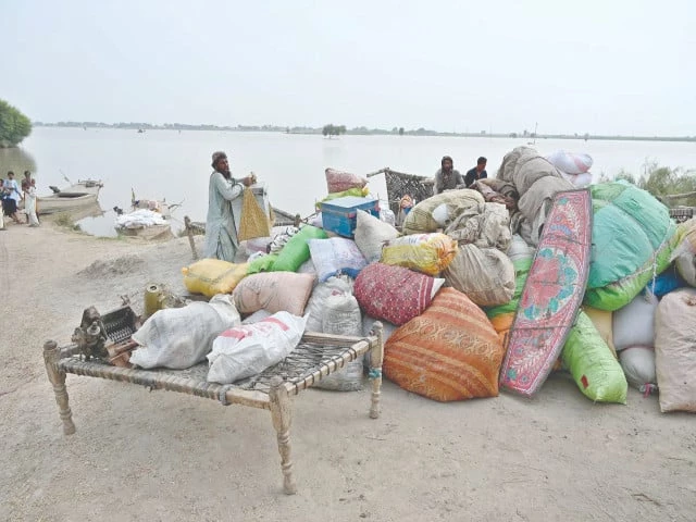 flood hit residents of nizam kalhoro village in the indus river s katcha belt carry their belongings to safer ground after authorities issued a flood warning photo app flood hit residents of nizam kalhoro village in the indus river s katcha belt carry their belongings to safer ground after authorities issued a flood warning photo app