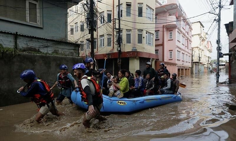 security force members use an inflatable raft to bring residents to safety from a flooded area near the bank of the overflowing bagmati river following heavy rains in kathmandu nepal september 28 reuters