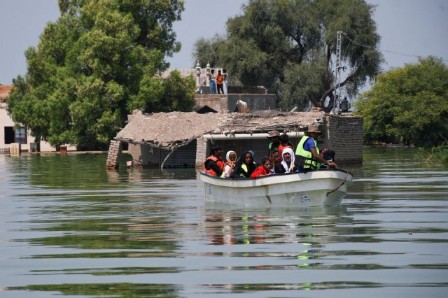 rescued flood victims sit in a boat following rains and floods during the monsoon season in village arazi in sehwan pakistan september 11 2022 photo reuters rescued flood victims sit in a boat following rains and floods during the monsoon season in village arazi in sehwan pakistan september 11 2022 photo reuters