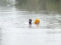 a farmer swims while using an empty canister through a flooded area near qasim bela village on the outskirts of multan photo reuters