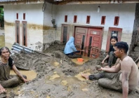 dozens of people were killed in indonesia s aceh province where residents cleared mud from flooded homes photo afp