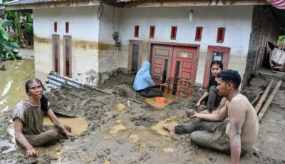 dozens of people were killed in indonesia s aceh province where residents cleared mud from flooded homes photo afp