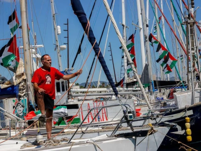 an activist stands on a sailboat from the global sumud flotilla humanitarian expedition as it prepares to set sail for gaza at the port of barcelona spain august 30 2025 photo reuters