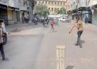 flour fury youngsters play cricket outside shuttered shops in jodia bazaar during a traders strike on wednesday photos jalal qureshi express