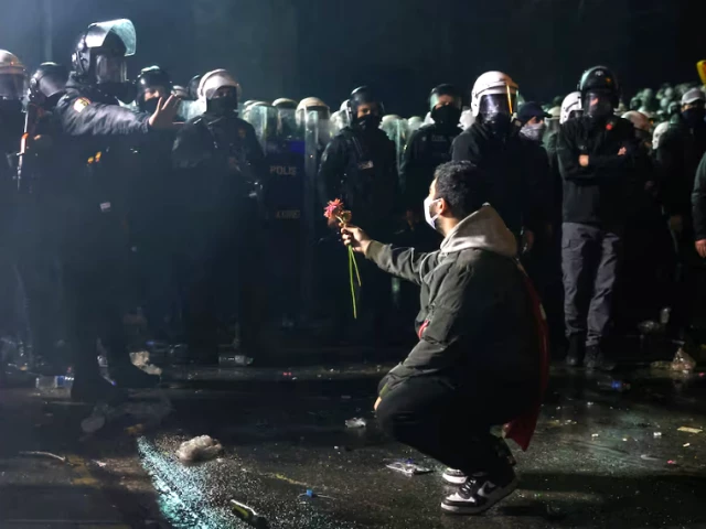 a person holds a flower towards police officers in istanbul march 23 photo reuters a person holds a flower towards police officers in istanbul march 23 photo reuters