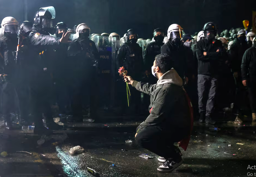 a person holds a flower towards police officers in istanbul march 23 photo reuters