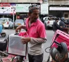 a foodpanda delivery rider loads items into his delivery box before delivering them in karachi pakistan march 13 2026 photo reuters