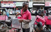 karachi s delivery riders race for eid but iran war squeezes earnings