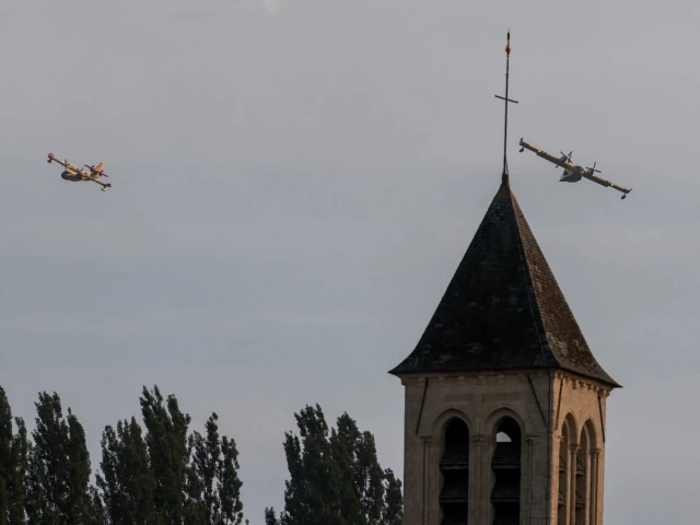 firefighting planes canadair cl 415 fly over the church of noisy sur ecole amid a wildfire affecting the area near fontainebleau france july 13 2026 photo reuters firefighting planes canadair cl 415 fly over the church of noisy sur ecole amid a wildfire affecting the area near fontainebleau france july 13 2026 photo reuters