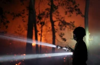 a firefighter sprays water to extinguish flames in the fontainebleau forest during a wildfire in le vaudoue during a heatwave affecting large parts of france july 13 2026 photo reuters file
