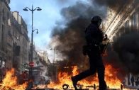 french riot police walk past burning objects in a street amid clashes with protesters in paris as part of nationwide protests against the cost of living and rising fuel prices called by the yellow vests movement joined by french high school and university students teachers and parents demanding better school conditions and government action as well as labour unions workers farmers and retirees france october 17 2026 photo reuters