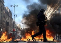 french riot police walk past burning objects in a street amid clashes with protesters in paris as part of nationwide protests against the cost of living and rising fuel prices called by the yellow vests movement joined by french high school and university students teachers and parents demanding better school conditions and government action as well as labour unions workers farmers and retirees france october 17 2026 photo reuters