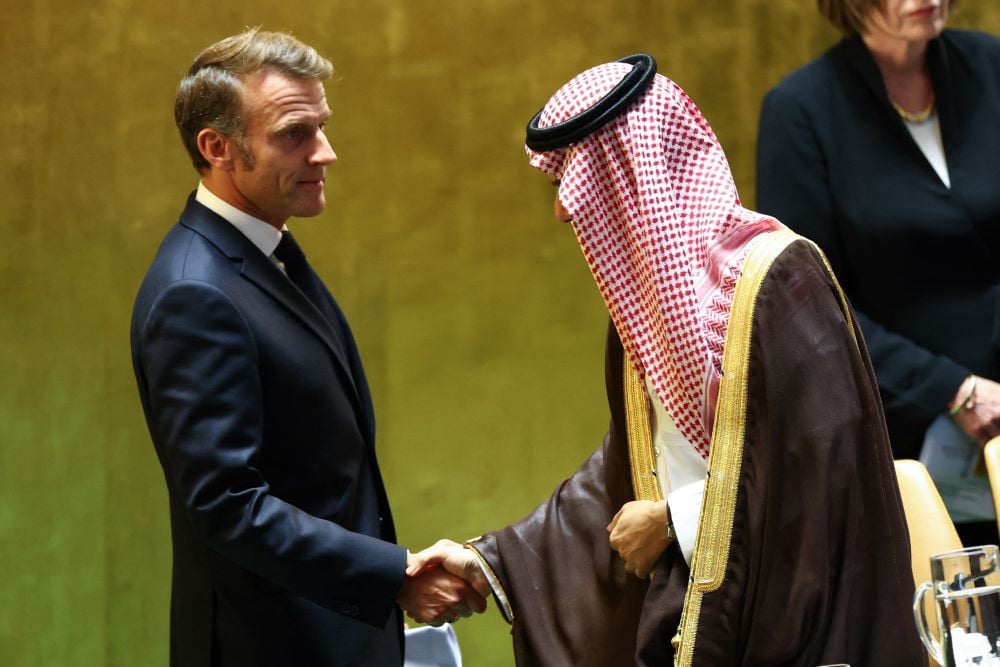 (L/R) France's President Emmanuel Macron shakes hands with Saudi Arabia's Foreign Minister Faisal bin Farhan Al-Saud after Macron concluded his remarks during a United Nations Summit on Palestinians at UN headquarters during the United Nations General Assembly. PHOTO: AFP