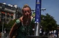 a woman cools off in a public fountain near the place du trocadero during high temperatures amid a heatwave in paris france on june 27 2026 photo reuters