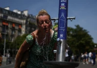 a woman cools off in a public fountain near the place du trocadero during high temperatures amid a heatwave in paris france on june 27 2026 photo reuters