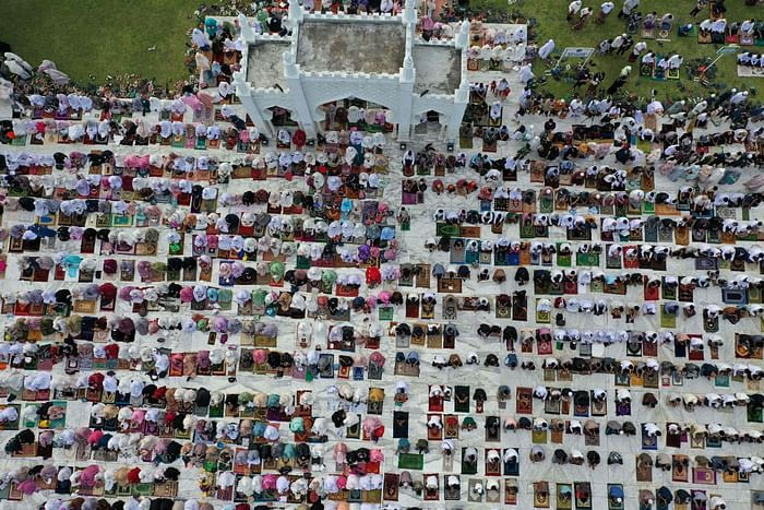 This aerial picture taken on July 20, 2021 shows Muslims attending prayers to mark the Eidul Azhar festival at the Baiturrahman Grand Mosque in Banda Aceh, Indonesia. PHOTO: AFP