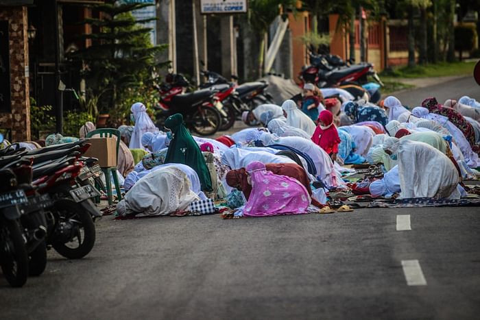 Muslims gather on the road to pray outside a mosque to mark Eidul Azha, the annual celebration known as the Festival of Sacrifice, in Ungaran, Central Java on July 20, 2021. PHOTO: AFP