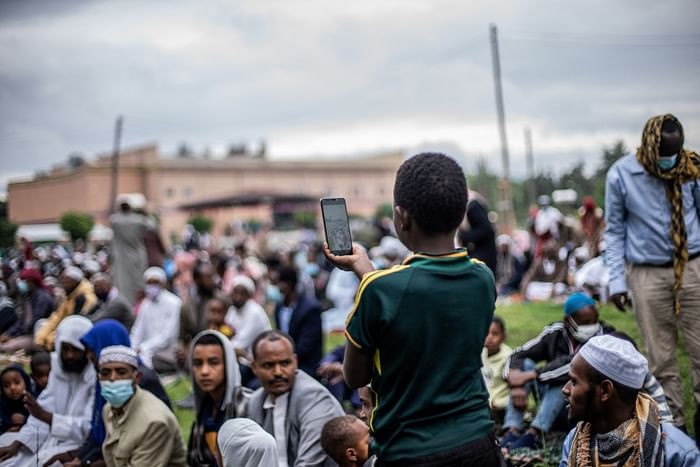 A muslim boy takes pictures during the Eidul Azha prayers on the first day of the feast celebrated by Muslims worldwide, at the Millennium Square in Hawassa, Ethiopia, on July 20, 2021. PHOTO: AFP