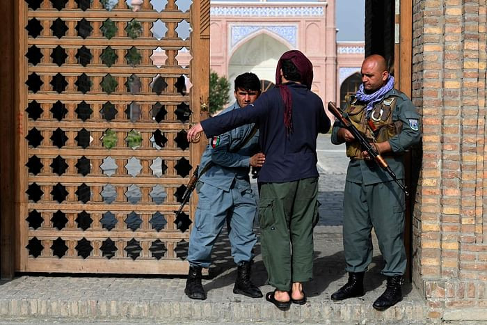 An Afghan security personnel frisks a devotee at the entrance of a mosque during the Eidul Azha prayers in Kabul on July 20, 2021. PHOTO: AFP