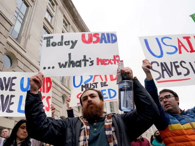 people hold placards outside the usaid building after billionaire elon musk said work is underway to shut down the us foreign aid agency usaid in washington us on february 3 2025 photo reuters people hold placards outside the usaid building after billionaire elon musk said work is underway to shut down the us foreign aid agency usaid in washington us on february 3 2025 photo reuters