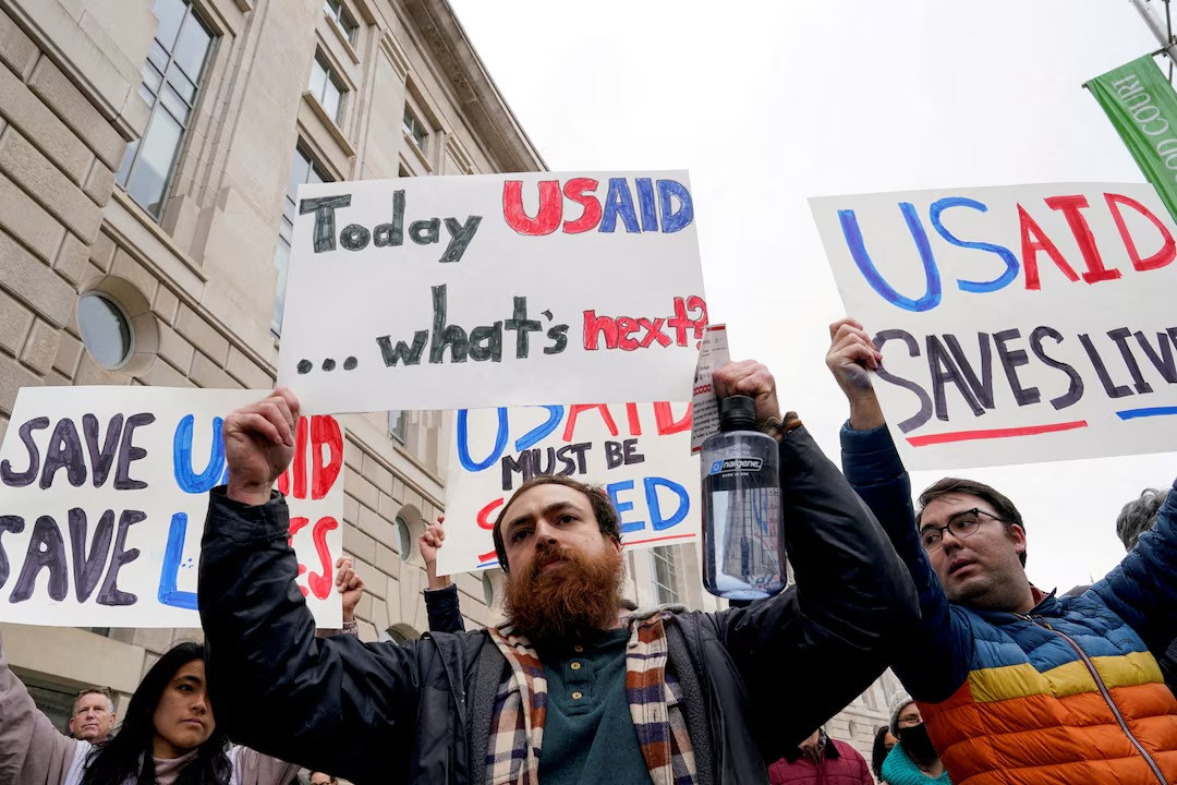 people hold placards outside the usaid building after billionaire elon musk said work is underway to shut down the us foreign aid agency usaid in washington us on february 3 2025 photo reuters