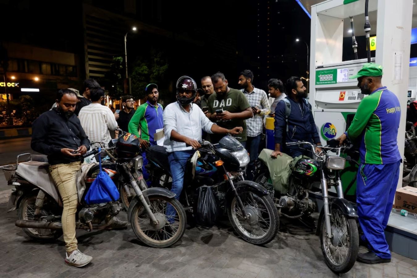 People wait to refuel their motorcycles at a petrol station following the rollout of a fuel relief scheme, which provides a fuel subsidy for eligible motorcycles, rickshaws and vehicles with engines of up to 800cc, in Karachi, Pakistan, September 17, 2026. REUTERS