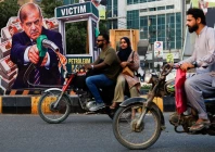 people on motorbikes ride past a portrait of pakistani prime minister shehbaz sharif set up in protest against rising fuel prices amid the u s  iran conflict ahead of the nationwide rollout of a government scheme offering a rs100 per litre subsidy to eligible motorcycles rickshaws and vehicles up to 800cc in karachi pakistan september 16 2026 reuters