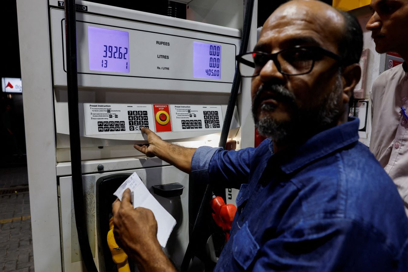 A worker updates the fuel price at a petrol station following the rollout of a fuel relief scheme, which provides a fuel subsidy for eligible motorcycles, rickshaws and vehicles with engines of up to 800cc, in Karachi, Pakistan, September 16, 2026. REUTERS